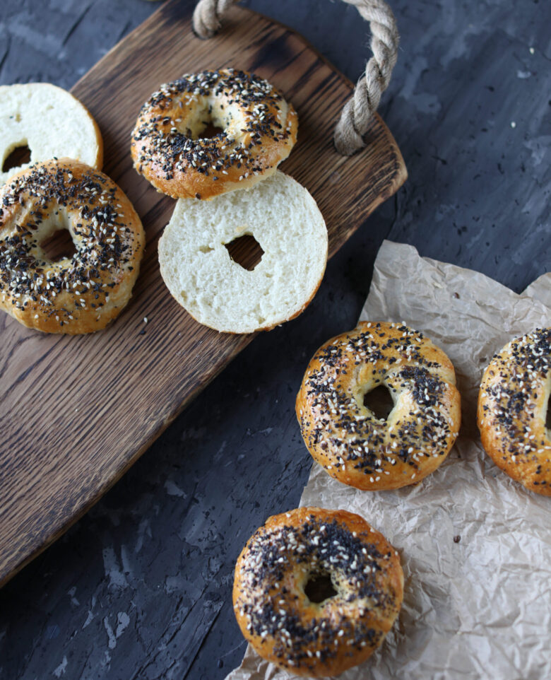 Homemade Bagels Sliced on Cutting Board.