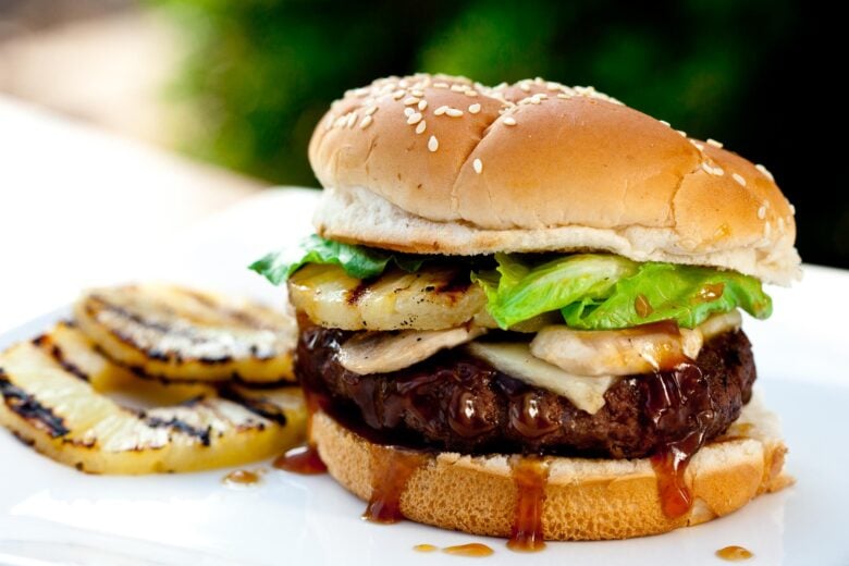 Teriyaki burgers with beef patty, grilled pineapples, and sauce