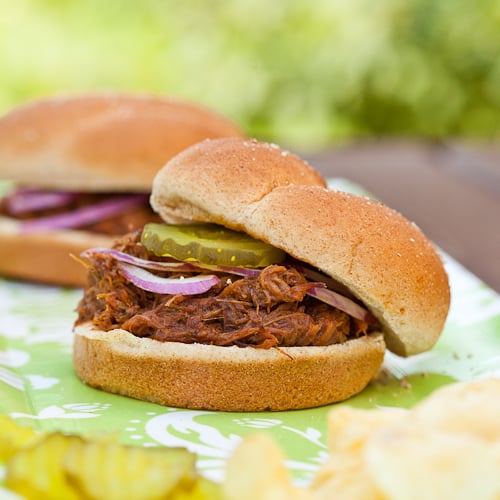 smoky pulled pork in buns with potato chips and pickles