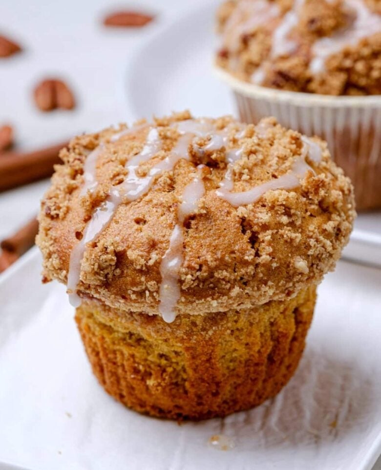 sweet potato muffins with streusel and icing on top.