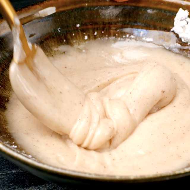 Spiced glaze being mixed in a bowl for pumpkin scones.