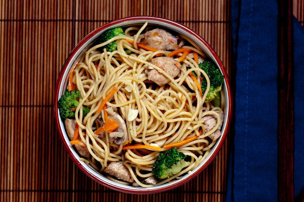 Chicken Chow Mein with Vegetables and chopsticks