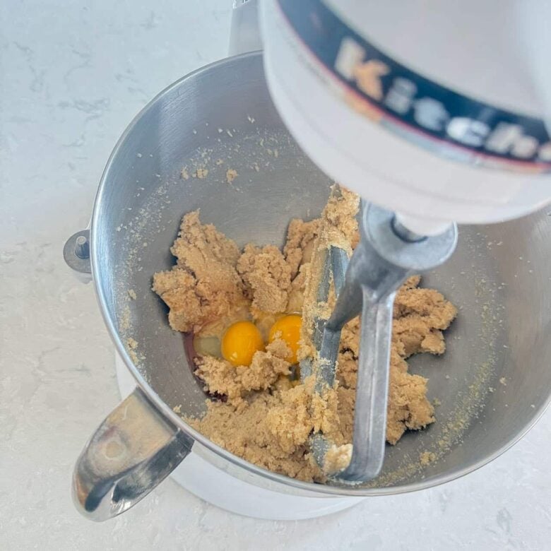 Oatmeal Chocolate Chip Cookies Ingredients such as Eggs and Vanilla In Mixing Bowl.