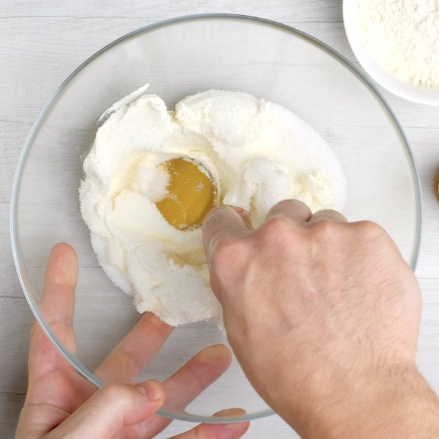 Cream cheese and sugar being mixture for cheesecake layer.