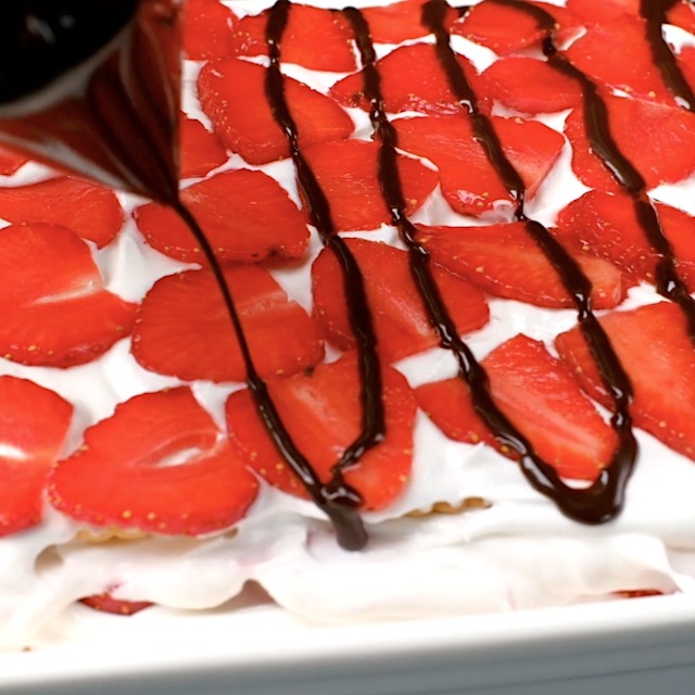 Simple ganache being drizzled over strawberry icebox cake.