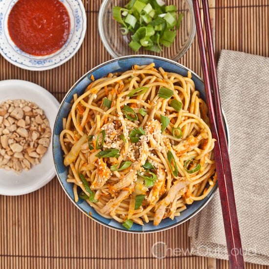 Peanut Sesame Noodles in bowl with condiments and chopsticks
