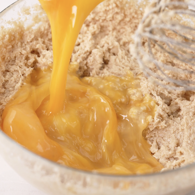 Egg being added to creamed butter-sugar mixture.