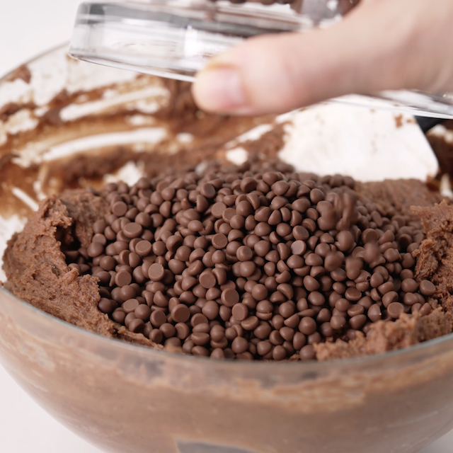 Mini chocolate chips being mixed in.
