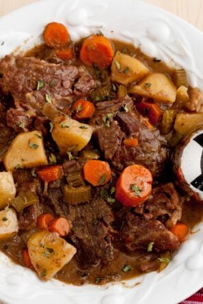 pot roast in a dish with a spoon on the side