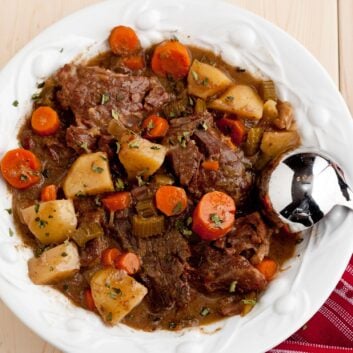 pot roast in a dish with a spoon on the side