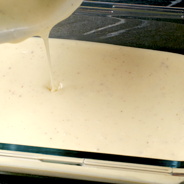 Pumpkin bundt cake filling being poured into a glass dish to be chilled in the fridge.