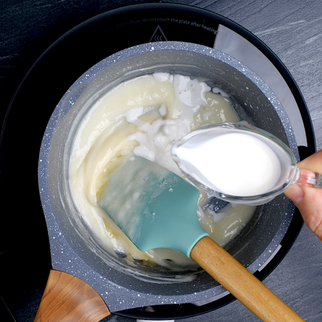 Cream cheese glaze being made in a bowl for pumpkin bundt cake.