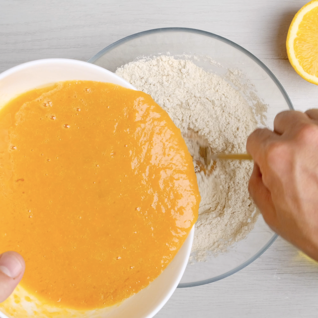 Wet ingredients to make sweet potato bread being mixed into dry mixture.