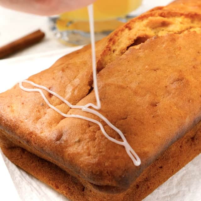 Icing being drizzled on sweet potato bread.