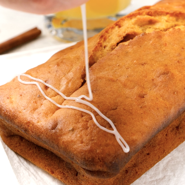 Icing being drizzled on sweet potato bread.