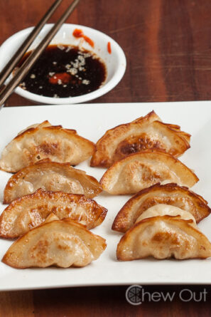 A Plate of Dumplings with Side Sauce
