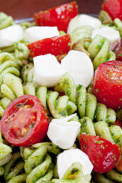 caprese pasta salad with tomatoes and mozzarella in a bowl