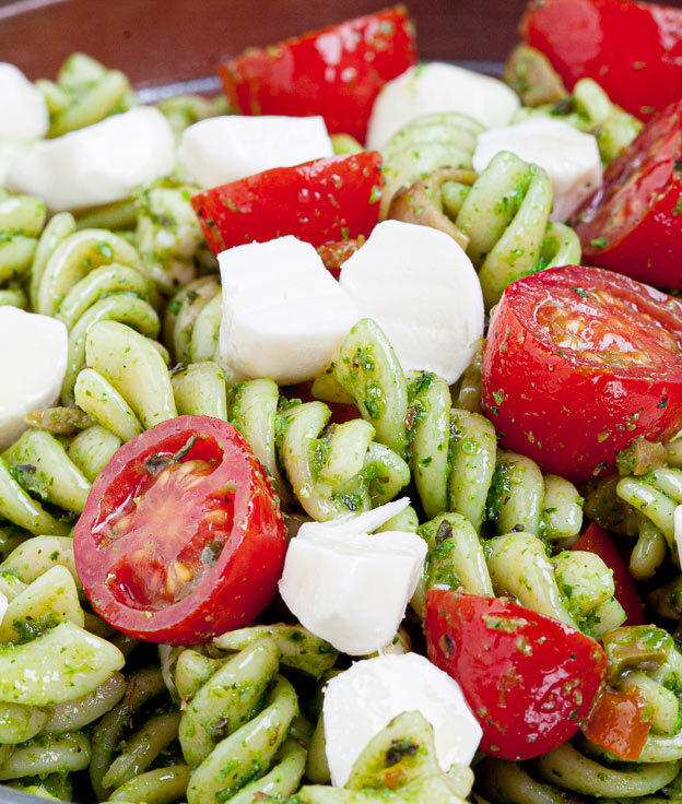 caprese pasta salad with tomatoes and mozzarella in a bowl