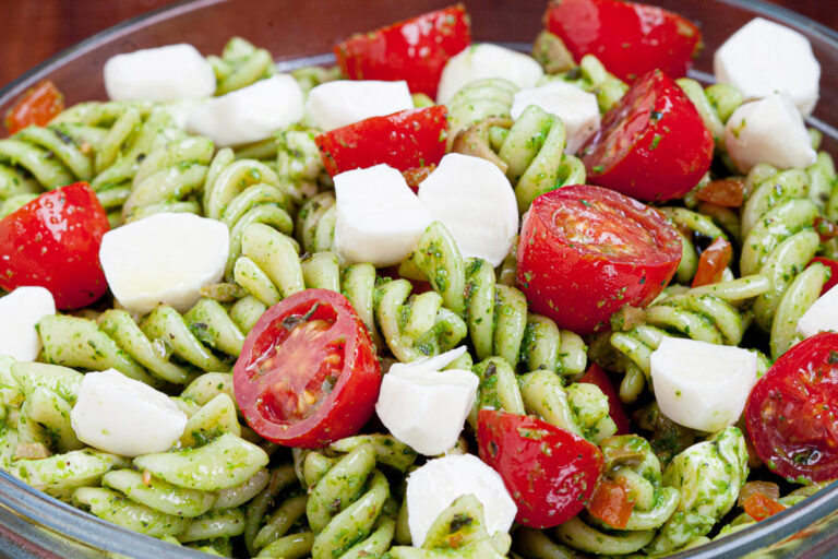 caprese pasta salad with tomatoes and mozzarella in a bowl