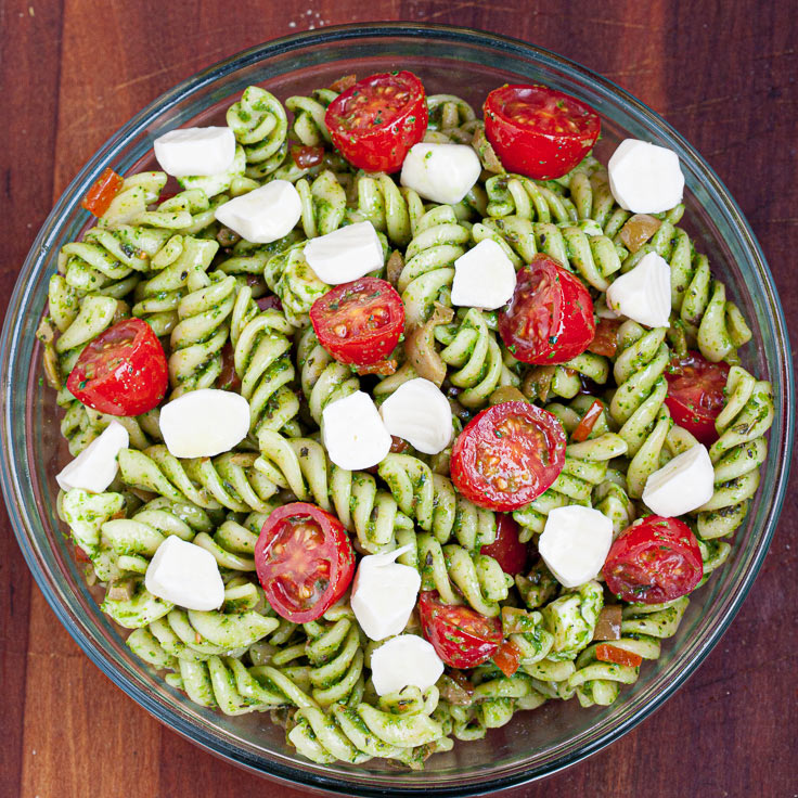 caprese pasta salad with tomatoes and mozzarella in a bowl