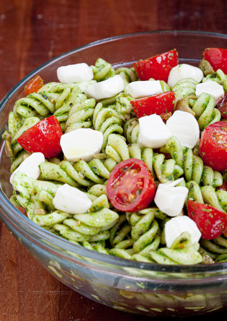 caprese pasta salad with tomatoes and mozzarella in a bowl