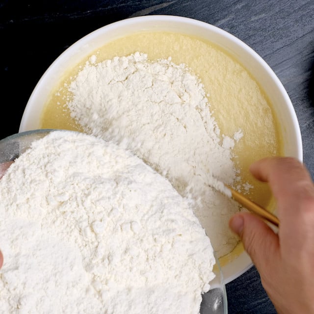 Dry ingredients being added into wet ingredients.