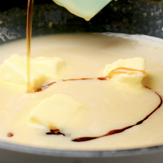 Vanilla and butter being added to a pan with caramel drizzle for brown sugar pound cake.