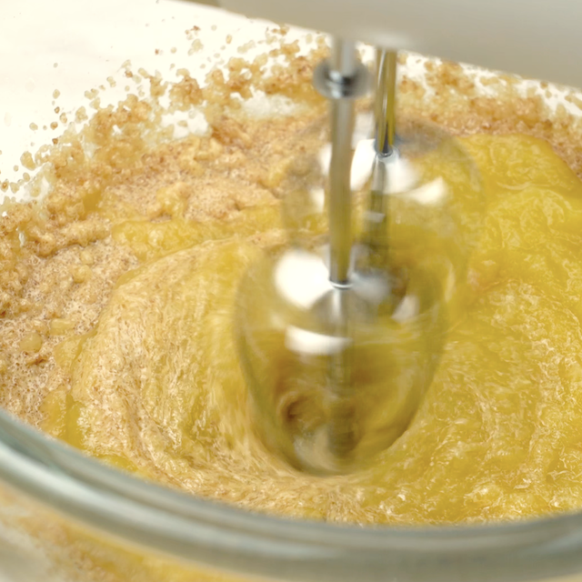 Pumpkin cookie batter being whisked together.