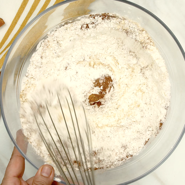 Dry ingredients being whisked to make pumpkin cookies at home.