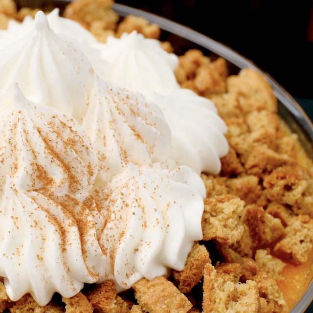 Pumpkin trifle garnished with whipped cream.