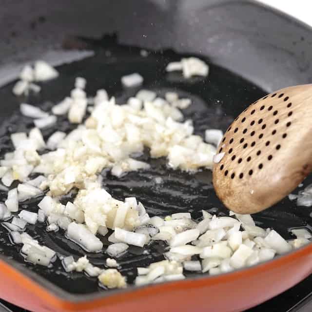 Aromatics being sauteed in a skillet to make skillet lasagna.