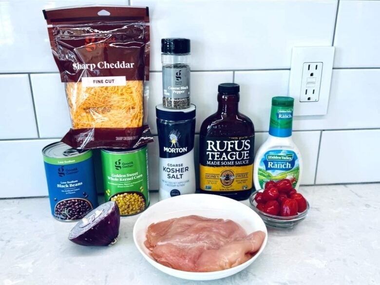 BBQ chicken salad ingredients includig sauce, chicken, cheese, and ranch.