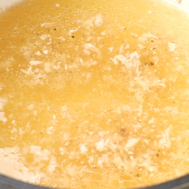 Liquid being reduced in a pot to make Cuban Mojo Pork.