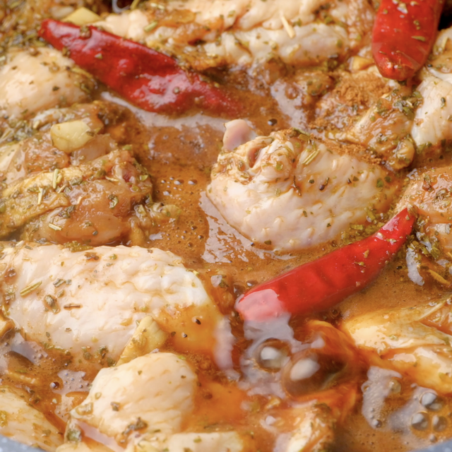 Closeup shot of wing chickens being braised in a pot to make Asian chicken wings at home.
