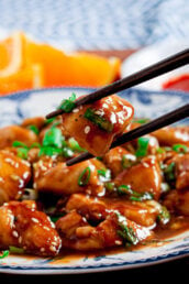 orange chicken with chopsticks