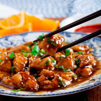 orange chicken with chopsticks