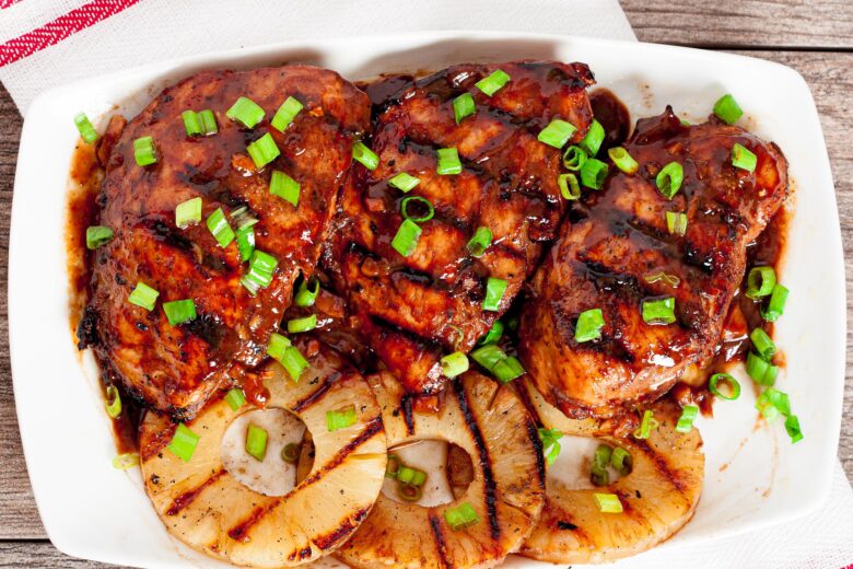 huli huli chicken with grilled pineapple rings on white plate