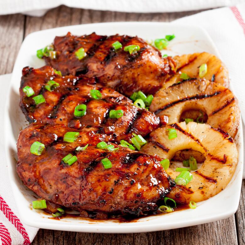 Hawaiian huli huli chicken with grilled pineapple rings on plate