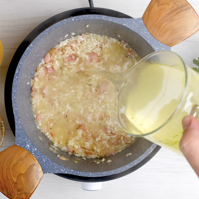 Hot stock being added to risotto pot.