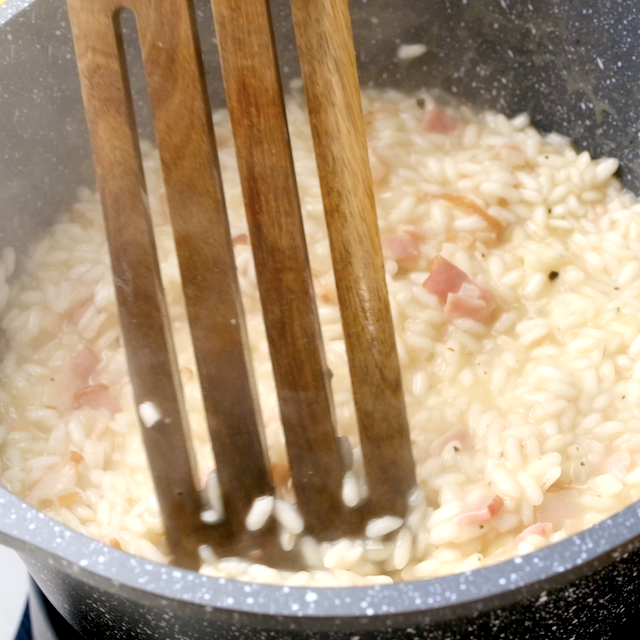 Butternut squash risotto being stirred.