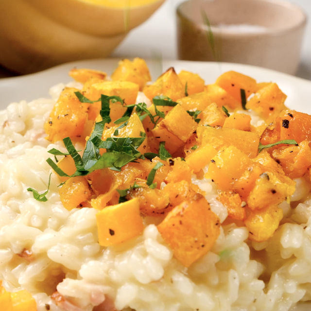 Butternut squash risotto served on a plate, ready to eat.