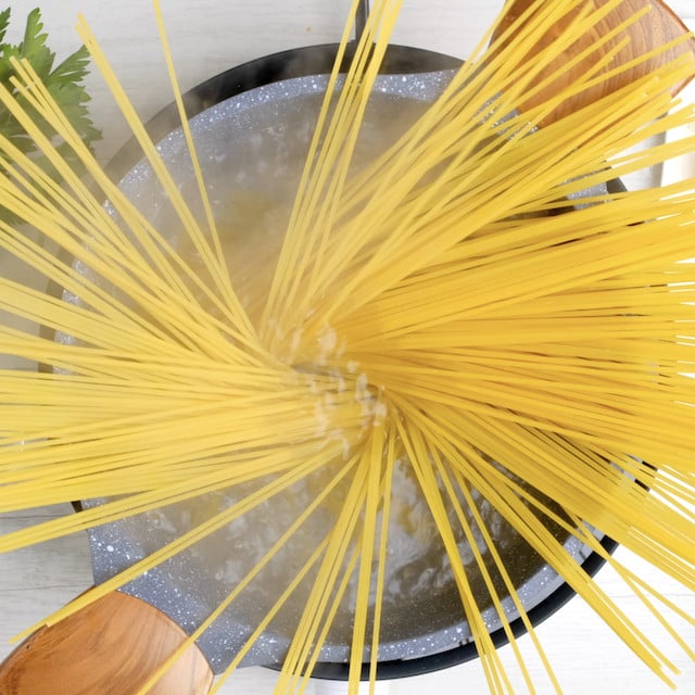 Spaghetti being cooked in water.