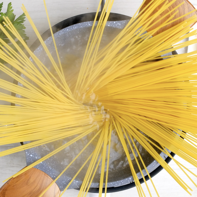 Spaghetti being cooked in water.