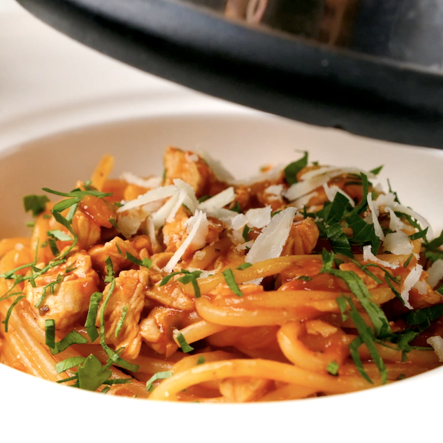Parmesan being shaved on top of homemade turkey bolognese.