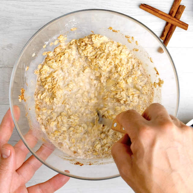 Batter to make baked blueberry oatmeal being mixed in a glass bowl.
