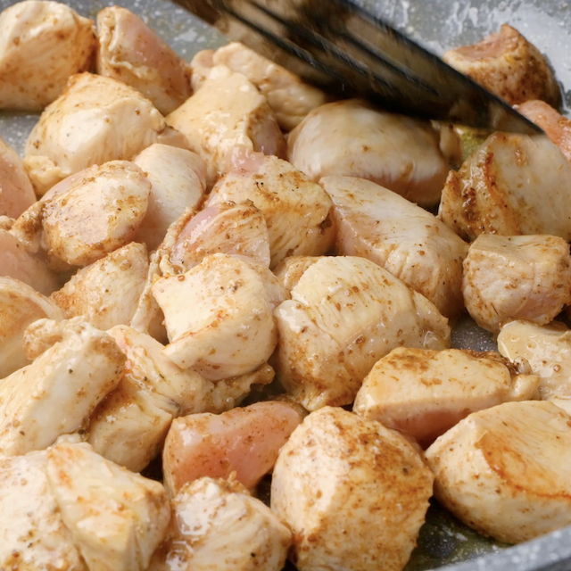 Chicken being cooked in a pan to make chicken fajita pasta.