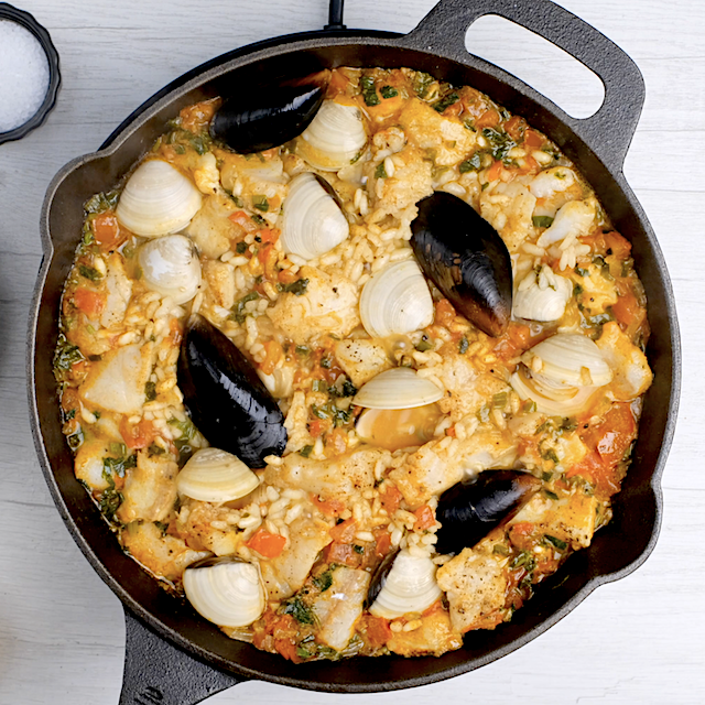 Mussels, clams, and shrimp added on top of paella to make seafood paella.
