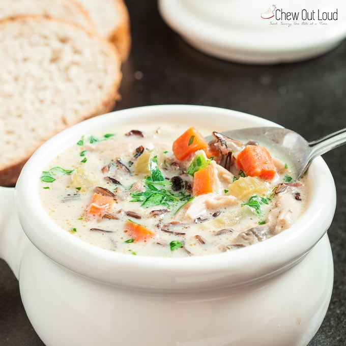 Creamy Chicken Wild Rice Soup in white bowl with spoon 