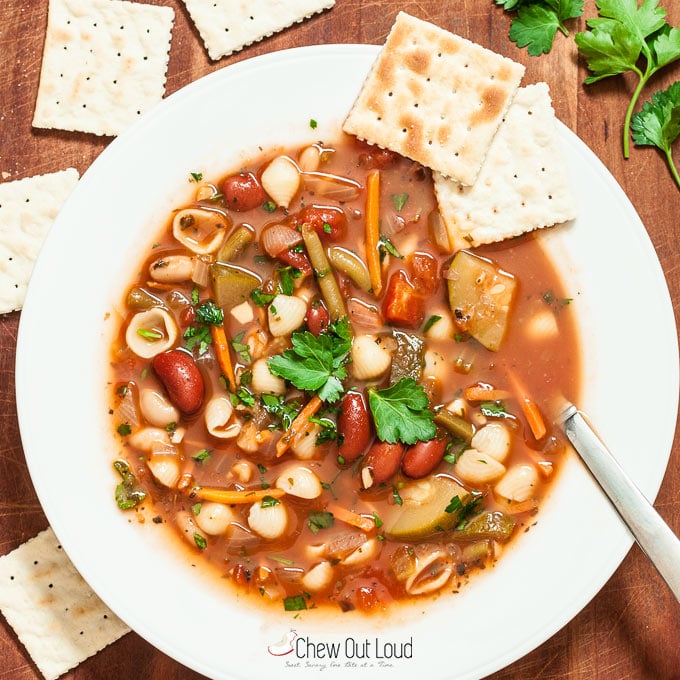 Healthy Minestrone Soup in white bowl with crackers