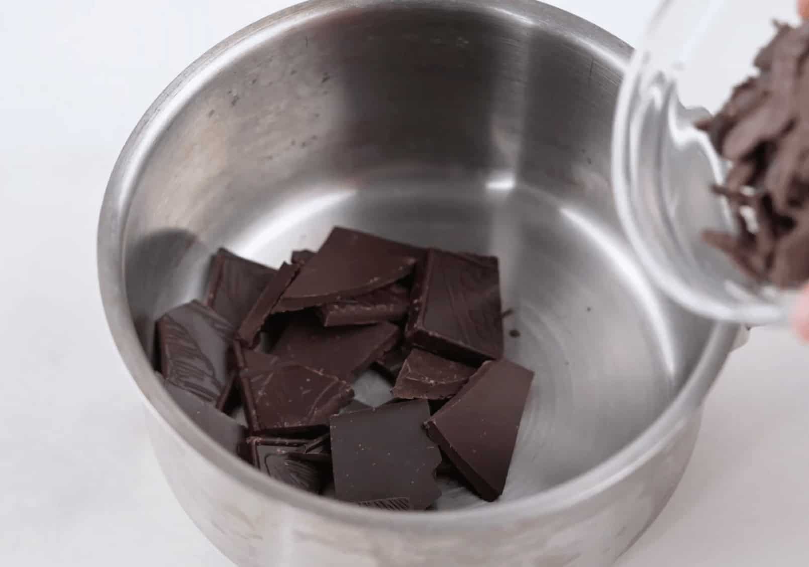 Melting the chocolate in a pan on the stovetop.